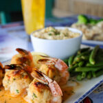 shrimp topped with crabmeat and green beans as a side dish