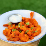 fried shrimp tossed in orange buffalo sauce with ranch on the side