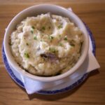 mashed potatoes in a bowl with parsley on top