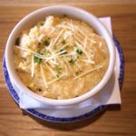 corn grits topped with parmesan cheese and parsley
