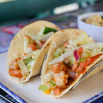 shrimp in a white flour tortilla with lettuce and tomatoes