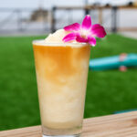 frozen drink with purple flower garnish